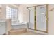 Bathroom with a large soaking tub and glass enclosed shower at 4024 Mansion Hall Ct, Las Vegas, NV 89129