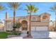 Inviting two-story home with arched entry, tile roof, and a well-manicured lawn at 4024 Mansion Hall Ct, Las Vegas, NV 89129