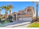 Inviting two-story home with arched entry, tile roof, and a well-manicured lawn at 4024 Mansion Hall Ct, Las Vegas, NV 89129