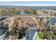 A two story home features a tile roof, desert landscaping, palm trees, and an arched entryway at 4024 Mansion Hall Ct, Las Vegas, NV 89129