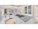 Gourmet kitchen with granite island, cooktop, ample cabinet space, and modern fixtures at 4024 Mansion Hall Ct, Las Vegas, NV 89129