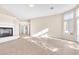 Open-concept living area with tile floors, a modern fireplace, and access to the backyard, great for gatherings at 4024 Mansion Hall Ct, Las Vegas, NV 89129