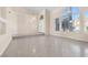 Spacious living area features tile floors, large windows and staircase leading to the front door at 4024 Mansion Hall Ct, Las Vegas, NV 89129