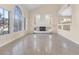 Bright living room boasts a fireplace, large windows, and neutral tile flooring at 4024 Mansion Hall Ct, Las Vegas, NV 89129