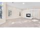 Spacious living room featuring a modern fireplace and plenty of natural light from large windows at 4024 Mansion Hall Ct, Las Vegas, NV 89129