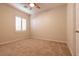Cozy bedroom featuring neutral walls, carpet floors, a ceiling fan, and large window at 4125 Gliding Gulls Ave, North Las Vegas, NV 89084