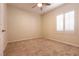 Cozy bedroom with neutral carpet, plantation shutters, and a ceiling fan, providing a tranquil retreat at 4125 Gliding Gulls Ave, North Las Vegas, NV 89084