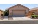 Charming one-story home showcasing a two-car garage and well-manicured front yard at 4125 Gliding Gulls Ave, North Las Vegas, NV 89084