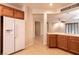 Bright kitchen with a refrigerator, wooden cabinets, tile floors, and an open layout at 4125 Gliding Gulls Ave, North Las Vegas, NV 89084