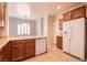 This kitchen showcases a large sink, dishwasher, refrigerator, and wooden cabinets at 4125 Gliding Gulls Ave, North Las Vegas, NV 89084