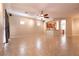 Open concept living room with tile flooring, ceiling fan, and adjoining kitchen area at 4125 Gliding Gulls Ave, North Las Vegas, NV 89084