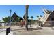 Community playground with slides, towers, and a dinosaur-themed structure for fun outdoor activities at 4125 Gliding Gulls Ave, North Las Vegas, NV 89084