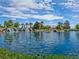 Reflective pond featuring a scenic waterfall and lush surroundings with palm trees at 4125 Gliding Gulls Ave, North Las Vegas, NV 89084