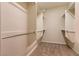 Walk-in closet with carpet floors, neutral walls, and built-in shelving and racks at 4125 Gliding Gulls Ave, North Las Vegas, NV 89084