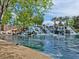 Scenic water feature with cascading waterfall, palm trees, and lush greenery at 4125 Gliding Gulls Ave, North Las Vegas, NV 89084