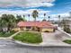 Inviting single-story home with a well-manicured lawn, palm trees and concrete driveway at 4170 Ridgecrest Dr, Las Vegas, NV 89121