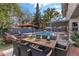 An inviting outdoor space with lounge chairs, an umbrella, and an outdoor dining set is ready for entertaining at 4330 Flandes St, Las Vegas, NV 89121