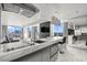 Modern kitchen and living room area with stainless steel appliances, marble counter tops and city views at 4381 W Flamingo Rd # 922, Las Vegas, NV 89103
