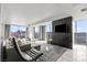 Bright, modern living room with floor to ceiling windows offering city views and a sleek entertainment center at 4381 W Flamingo Rd # 922, Las Vegas, NV 89103