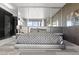 Modern main bedroom featuring a bed with a unique geometric pattern and floor to ceiling windows at 4381 W Flamingo Rd # 922, Las Vegas, NV 89103