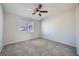 Bedroom features a ceiling fan, plush carpet, and a large window, offering ample natural light at 4495 Park View Dr, Las Vegas, NV 89104