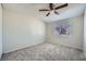 A neutral bedroom with a ceiling fan and plush carpet for maximum comfort and natural light at 4495 Park View Dr, Las Vegas, NV 89104