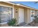 Home exterior featuring a white front door, large windows, and desert landscaping at 4495 Park View Dr, Las Vegas, NV 89104