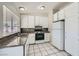 Well-lit kitchen with white cabinets, granite countertops, and modern appliances at 4495 Park View Dr, Las Vegas, NV 89104