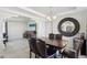 Elegant dining space with an overhead light fixture and views into the living area at 4528 Welter Ave, Las Vegas, NV 89104