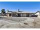 Rear exterior view of a single-story home with a covered patio and spacious yard at 4629 Cattleman Ave, North Las Vegas, NV 89031