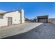 View of the home's backyard, featuring a long driveway and additional carport/garage at 4629 Cattleman Ave, North Las Vegas, NV 89031