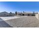 Large backyard featuring a long driveway and additional carport/garage at 4629 Cattleman Ave, North Las Vegas, NV 89031