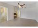 Large bedroom featuring tile floors, a ceiling fan, and access to an en-suite bathroom, creating a comfortable retreat at 4629 Cattleman Ave, North Las Vegas, NV 89031