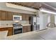 A kitchen featuring stainless steel appliances, tile countertops, and wooden cabinets at 4629 Cattleman Ave, North Las Vegas, NV 89031