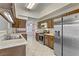 A kitchen featuring stainless steel appliances, wooden cabinets, and tile countertops at 4629 Cattleman Ave, North Las Vegas, NV 89031