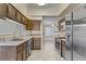 A kitchen featuring stainless steel appliances, wooden cabinets, and tile countertops at 4629 Cattleman Ave, North Las Vegas, NV 89031