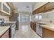 A kitchen featuring stainless steel appliances, tile countertops and flooring, and wooden cabinets at 4629 Cattleman Ave, North Las Vegas, NV 89031