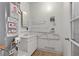 Functional laundry room featuring utility sink and water heater at 4629 Cattleman Ave, North Las Vegas, NV 89031