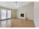 Inviting living room with tile floors, ceiling fan, and a cozy white-brick fireplace at 4629 Cattleman Ave, North Las Vegas, NV 89031