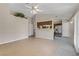 Living room featuring neutral walls, tile flooring, and open access to the kitchen at 4629 Cattleman Ave, North Las Vegas, NV 89031