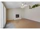 Living room featuring a white brick fireplace, light tile flooring, and a ceiling fan at 4629 Cattleman Ave, North Las Vegas, NV 89031