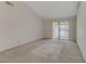 A bare living room with carpeted floor and lots of natural light at 4629 Cattleman Ave, North Las Vegas, NV 89031