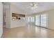 Living room featuring neutral walls, tile flooring, and a kitchen pass-through at 4629 Cattleman Ave, North Las Vegas, NV 89031