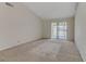A bare living room with carpeted floor and lots of natural light at 4629 Cattleman Ave, North Las Vegas, NV 89031