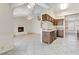 An open-concept living space with white brick fireplace and adjacent kitchen at 4629 Cattleman Ave, North Las Vegas, NV 89031