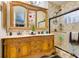 Bathroom features a double sink vanity with a decorative mirror and a glass enclosed shower at 489 Beaconwood St, Henderson, NV 89052