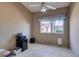 Bedroom with tiled floors, neutral colored walls, and a window bringing in natural light at 489 Beaconwood St, Henderson, NV 89052