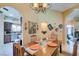 Chandelier-lit dining area open to kitchen and entryway, with decorative wall art and unique design at 489 Beaconwood St, Henderson, NV 89052