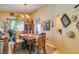 Dining area with a chandelier, wooden table set, and view of decorative walls and arched entryway at 489 Beaconwood St, Henderson, NV 89052