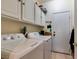 Laundry room equipped with a washer, dryer, ample cabinet space, and exterior access at 489 Beaconwood St, Henderson, NV 89052